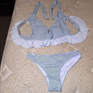 An unbranded 2 piece bikini  blue with white ruffles in a size medium.